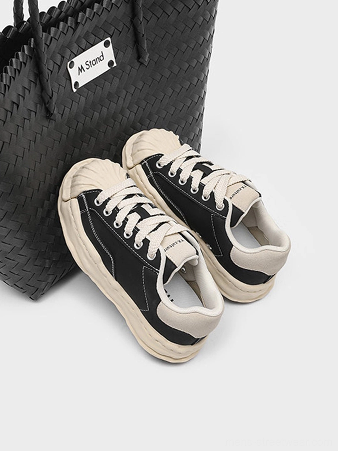 Black and beige shell-toe platform sneakers product image highlighting the retro-inspired toe cap and chunky lifted sole