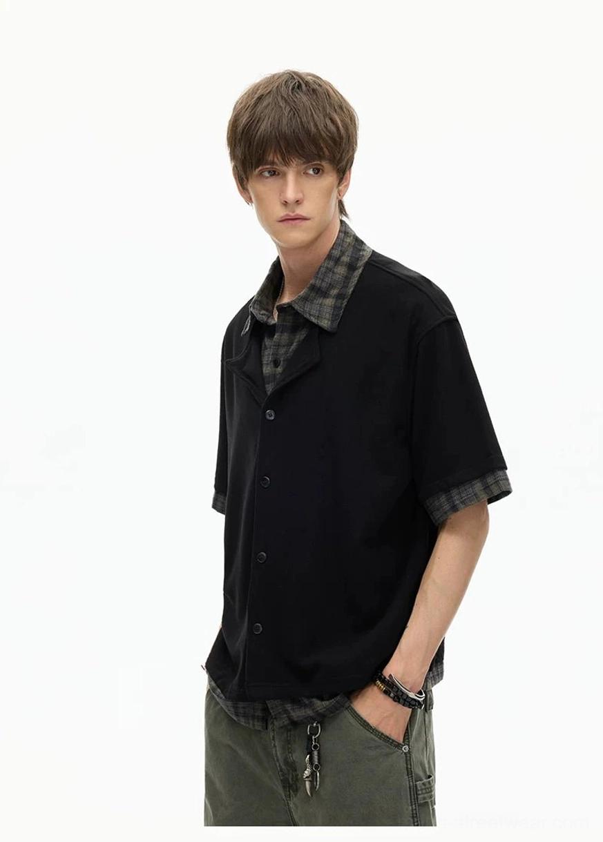 Black short-sleeve layered plaid hem knit shirt front view with exposed shirt collar and hem detail