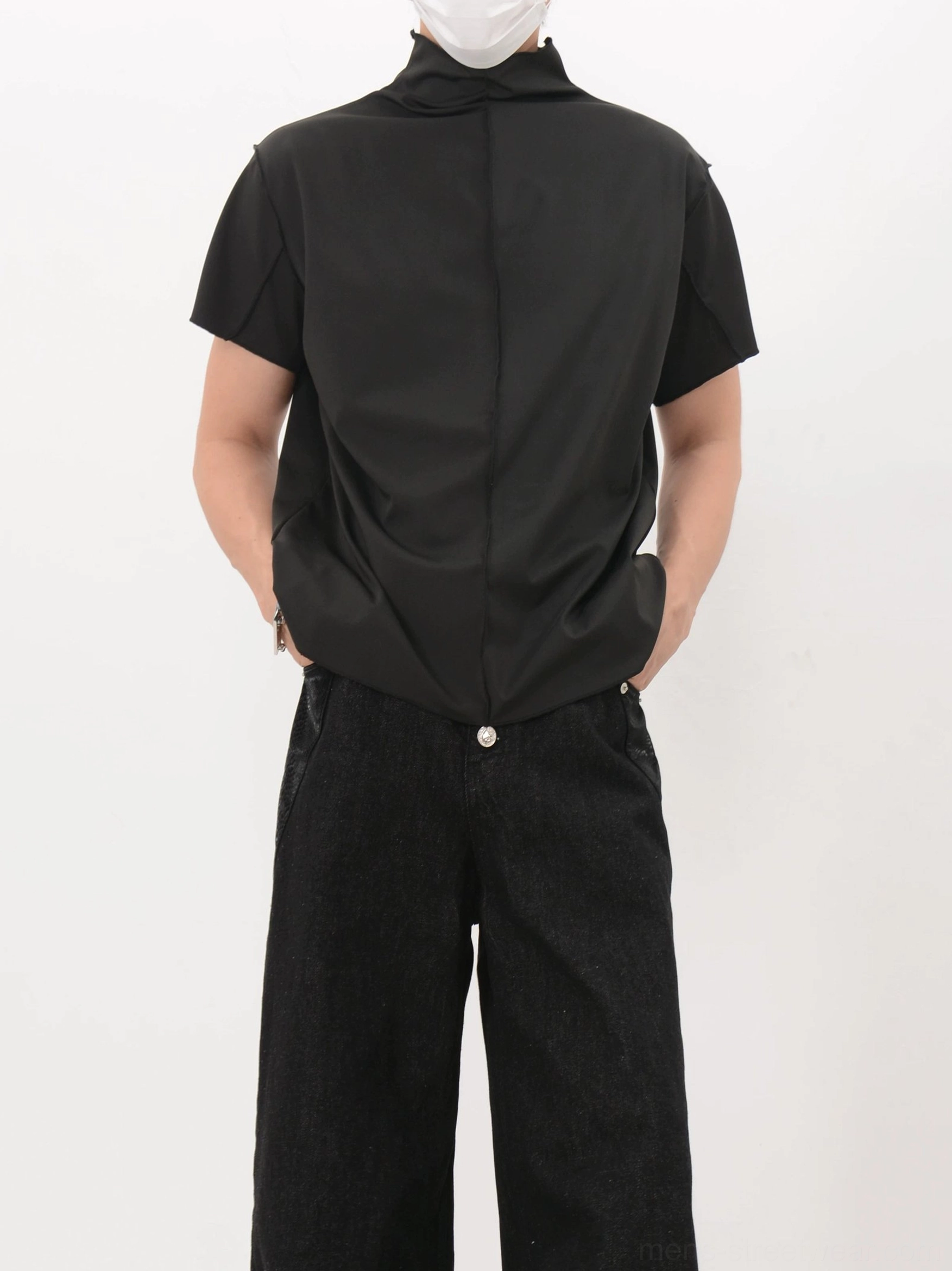 Black short-sleeve mock neck shirt shown from the rear with a clean silhouette and modern minimalist streetwear design