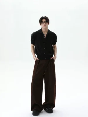 Black short sleeve polo knit cardigan with ribbed hem and cuffs styled with dark brown wide leg pants