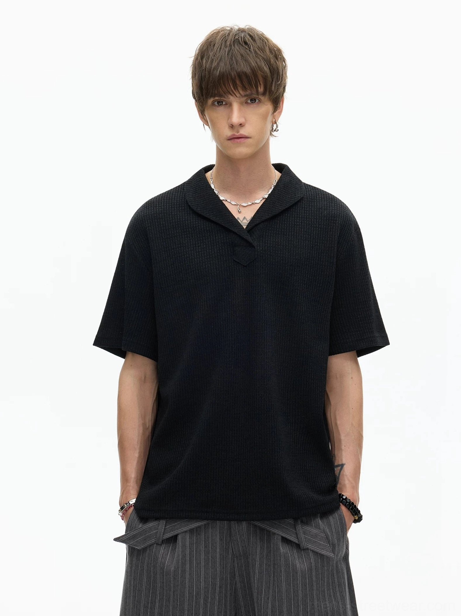 Front view of black short sleeve shawl collar knit polo tee showing waffle texture and clean relaxed Korean streetwear silhouette