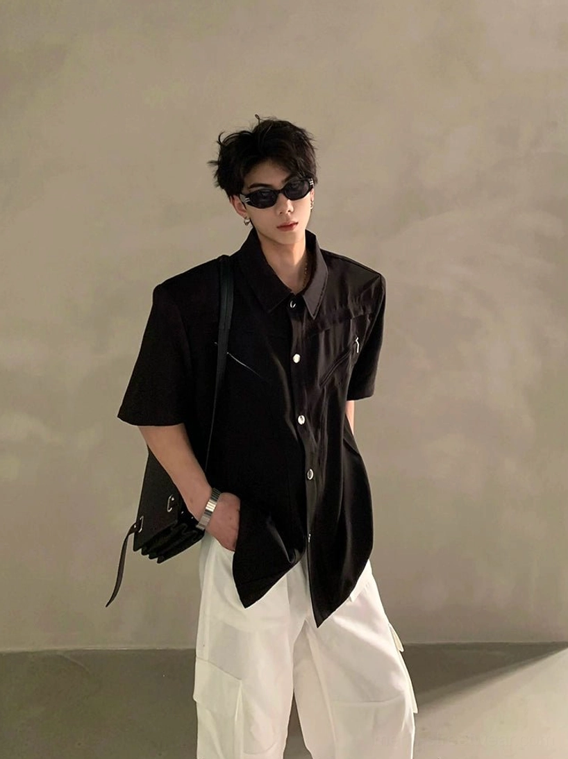 Black short sleeve button-down utility shirt styled with white wide-leg pants, sunglasses, black backpack, and contemporary Seoul streetwear attitude
