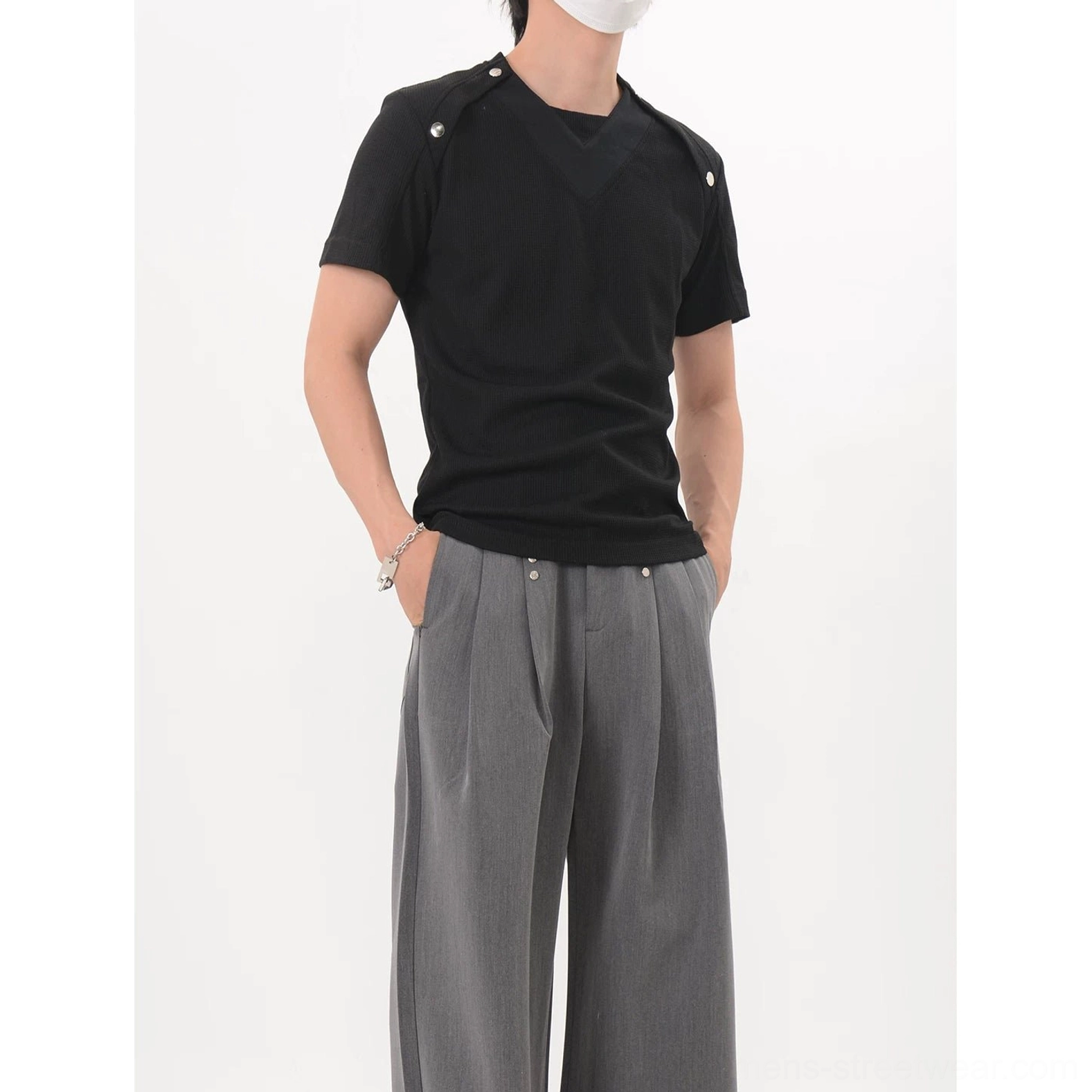 Black shoulder snap knit tee shown from the right rear with shoulder hardware and minimalist solid-color Korean fashion silhouette