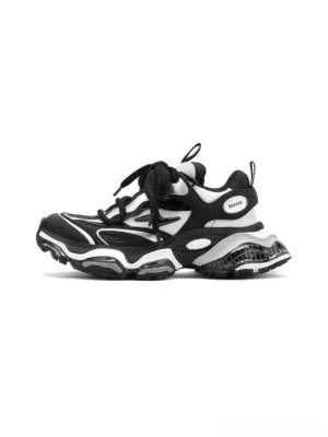 Black and silver air-cushioned chunky runner sneakers shown in a left side three-quarter view with layered leather panels, thick laces, raised midsole, and rugged streetwear outsole