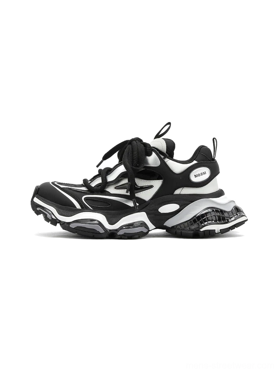 Black and silver air-cushioned chunky runner sneakers shown in a left side three-quarter view with layered leather panels, thick laces, raised midsole, and rugged streetwear outsole