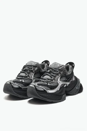 Black and silver chunky mesh platform sneakers shown from the front with metallic overlays and a thick ridged streetwear sole