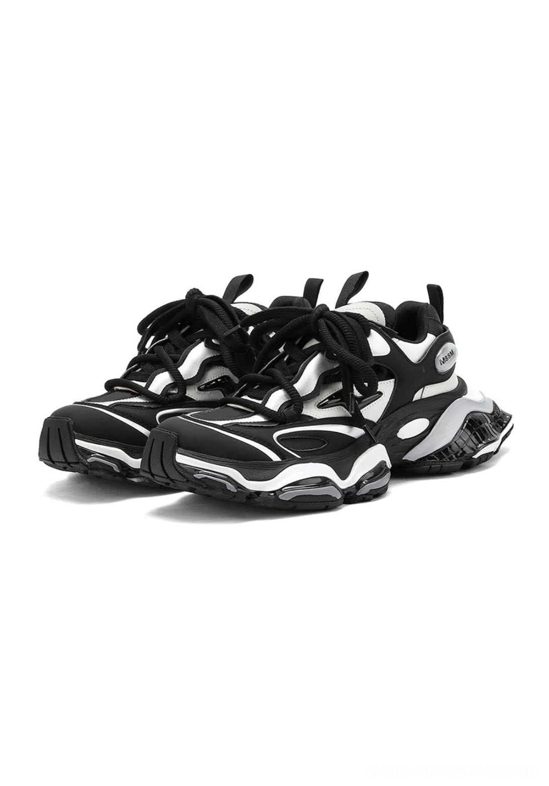 Black and silver chunky runner sneakers displayed from the front three-quarter angle with thick laces, symmetrical layered panels, and metallic silver accents