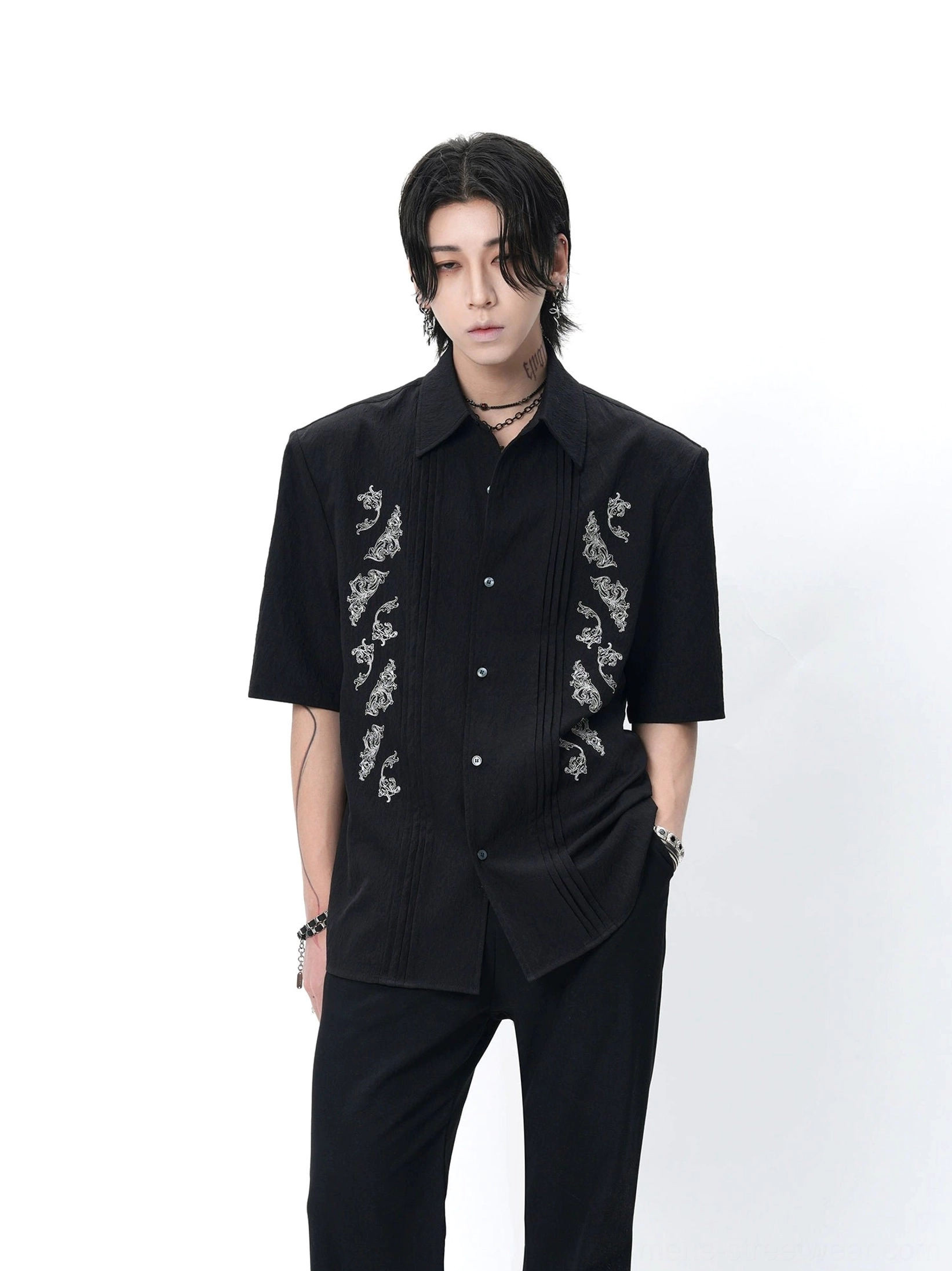 Black dragon embroidered Cuban shirt styled with black trousers in a full-body studio streetwear outfit