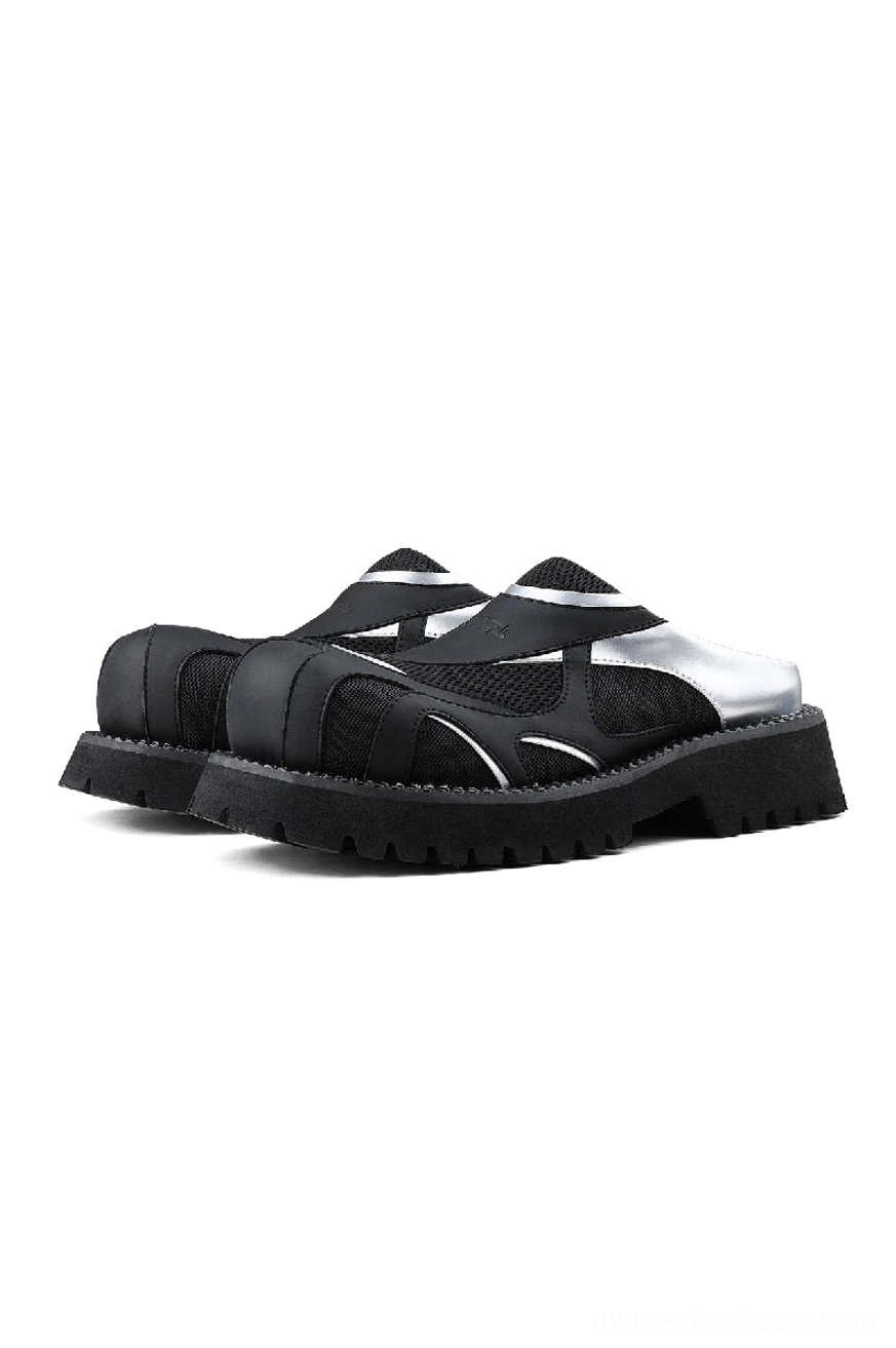 Front view of black and silver mesh platform slip-on mules with metallic accents and chunky black lug sole