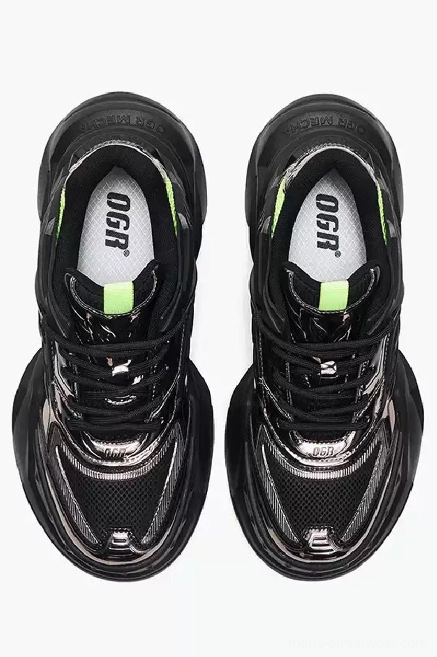 Top view of black silver and neon green chunky sneakers showing metallic toe caps laces and breathable streetwear design