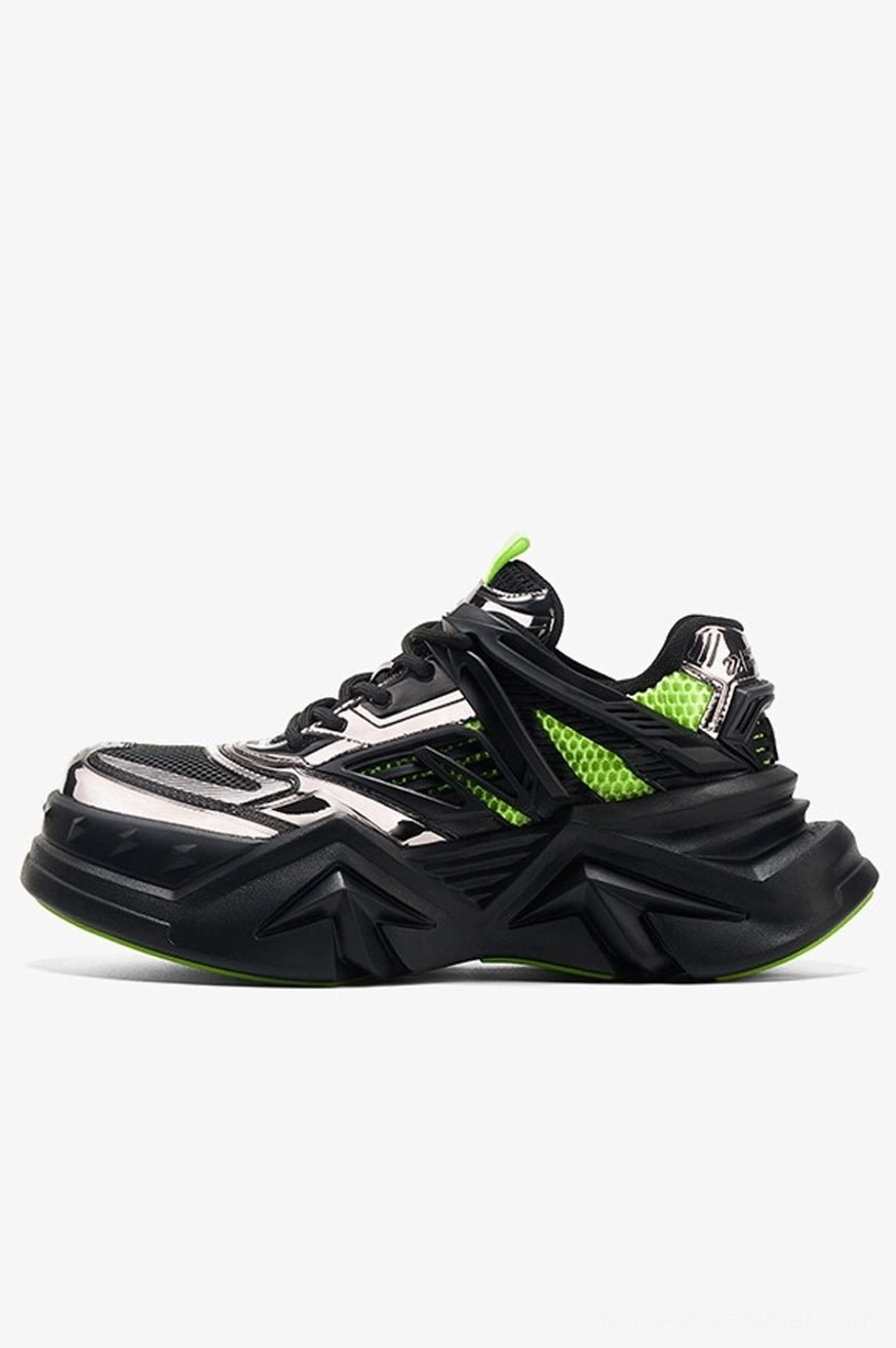 Black chunky techwear sneaker with silver mesh overlays neon green accents and futuristic geometric outsole side view