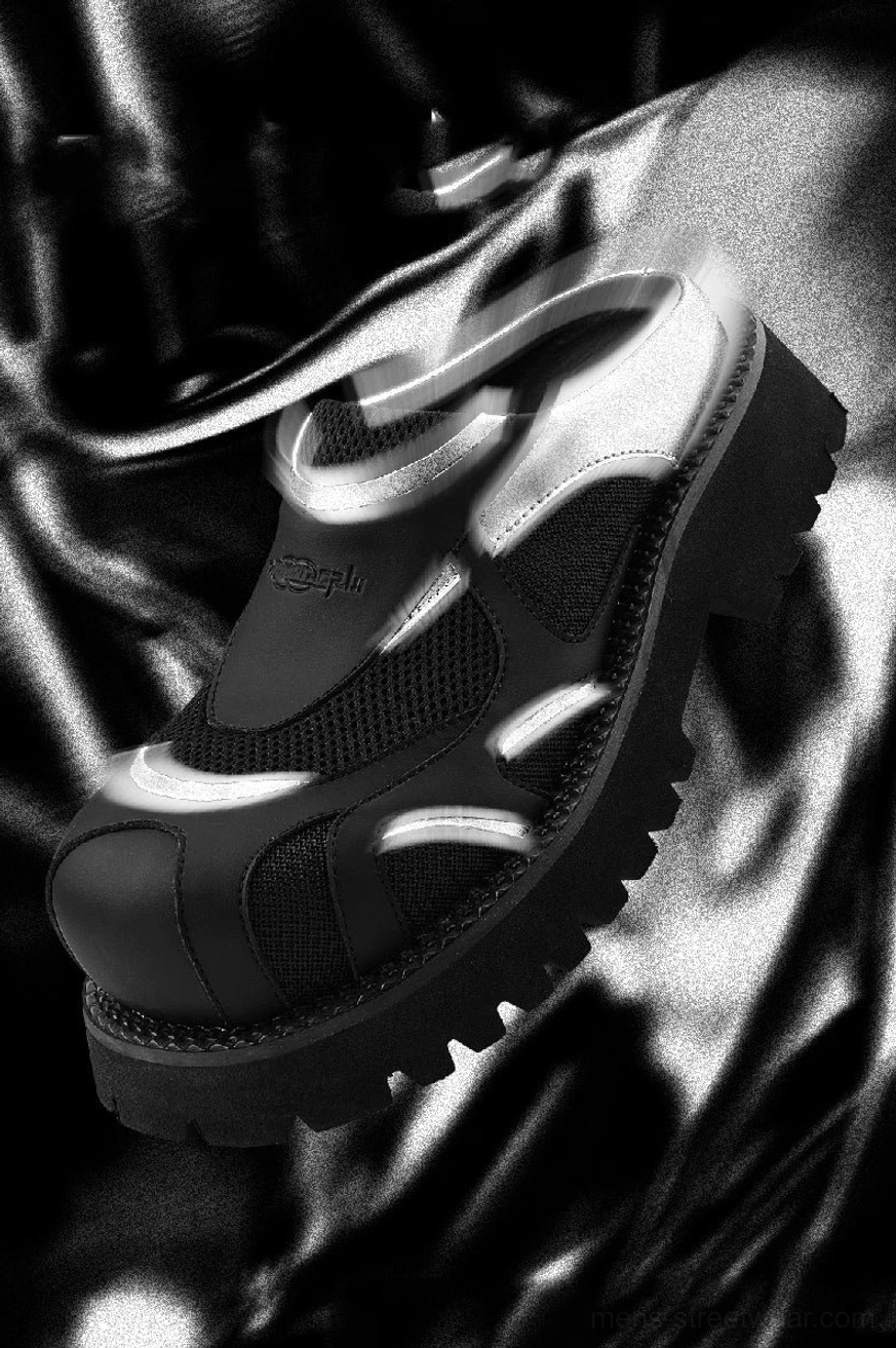 Close-up of black silver platform mules with ventilated mesh upper, metallic trim, and futuristic streetwear design