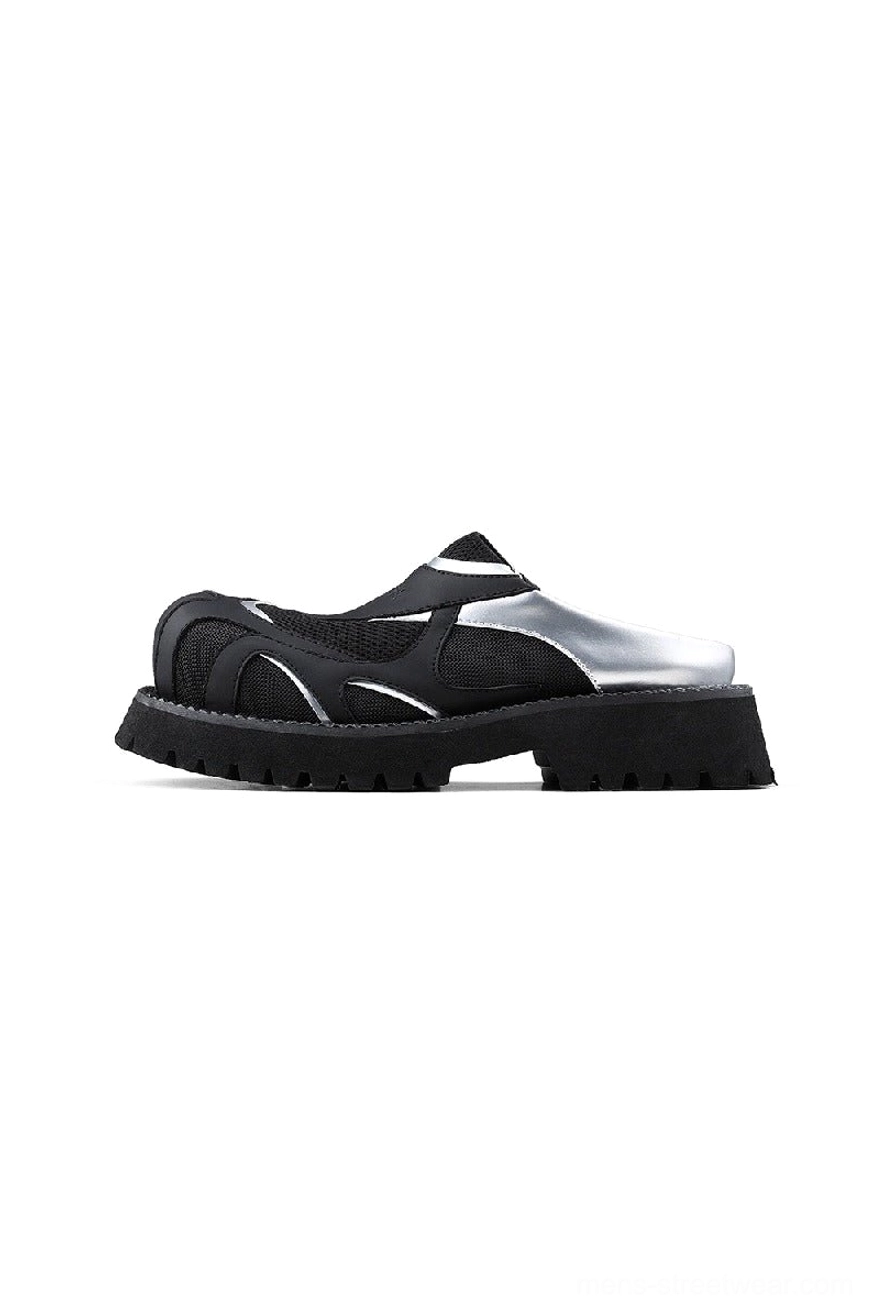 Side three-quarter view of black silver platform slip-on shoes with breathable mesh panels and thick lug outsole