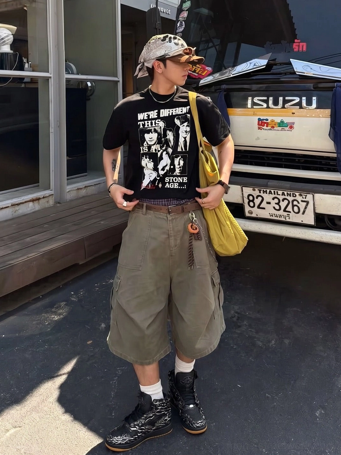 Black and silver Wukong high-top sneakers displayed on a standing streetwear model with cargo shorts and shoulder bag