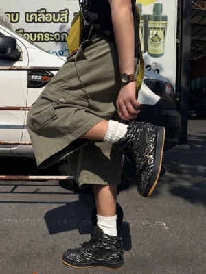 Black silver Wukong high-top sneakers worn with cargo shorts and white crew socks in an outdoor streetwear setting