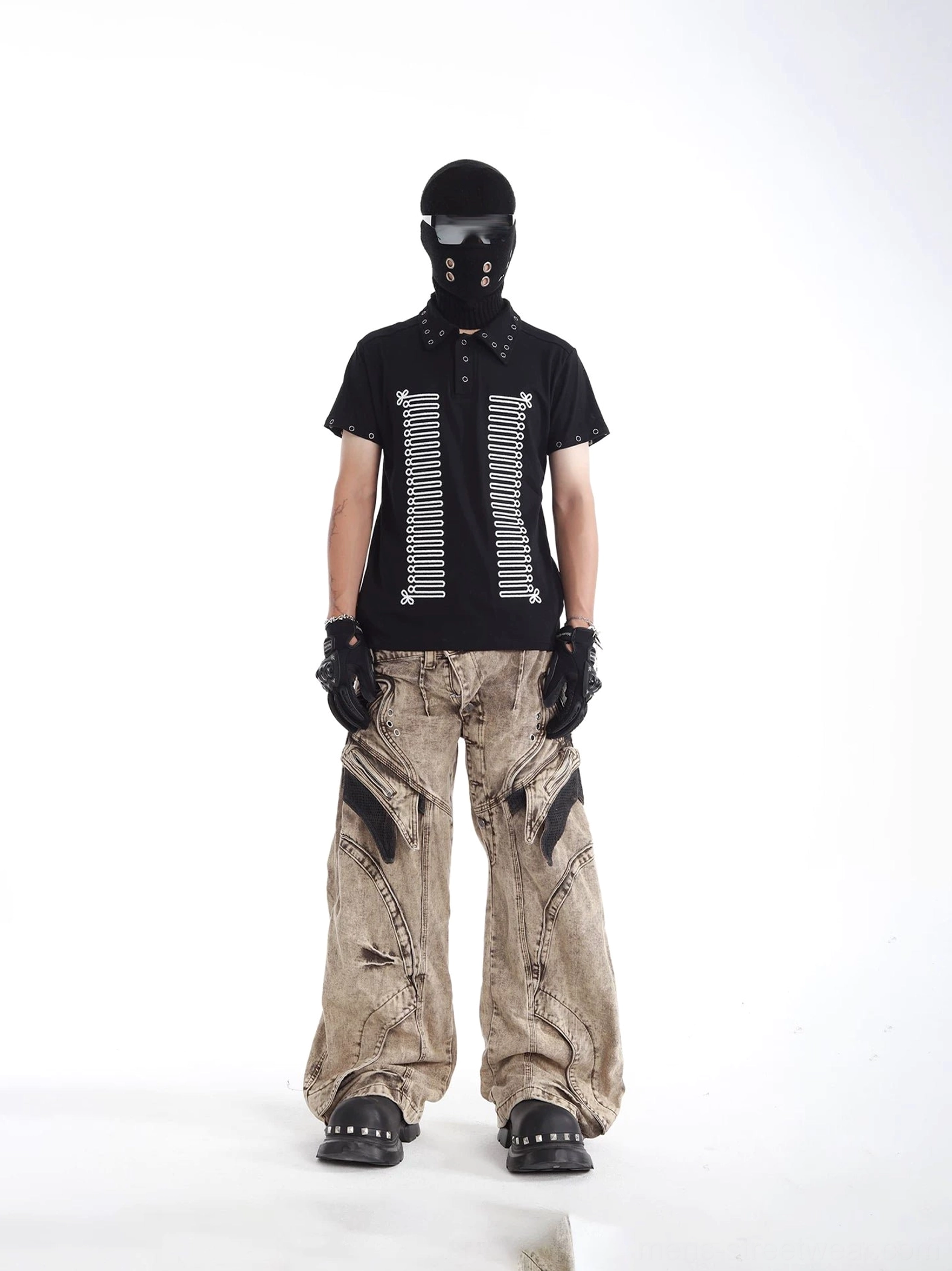 Black skeleton print polo shirt with industrial rivet trim on collar and cuffs, styled with camo wide-leg cargo pants for avant-garde streetwear