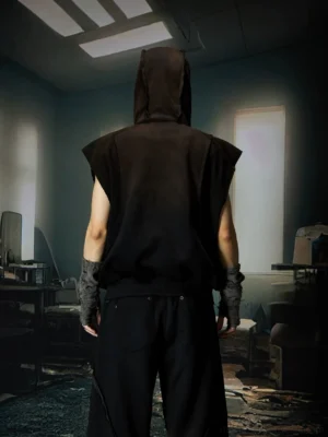 Back view of black sleeveless hooded vest showing attached hood and relaxed streetwear silhouette