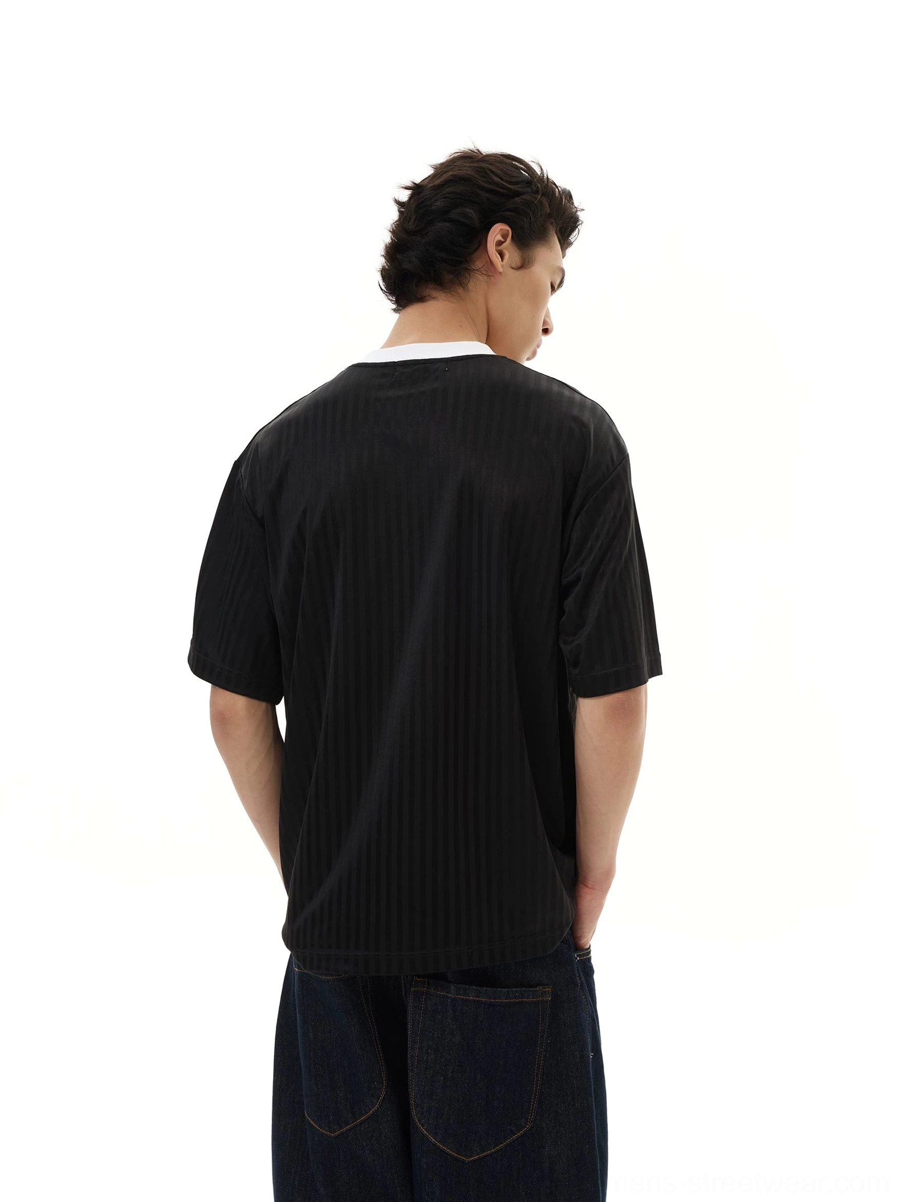 Back view of a black relaxed soccer jersey tee featuring subtle vertical pinstripes and an oversized below-hip silhouette