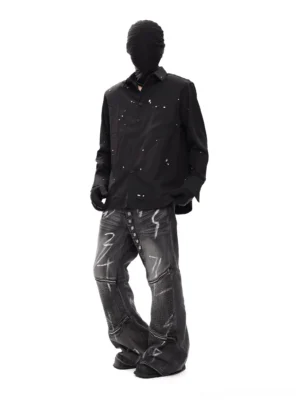 Side front view of black graphic splatter button up shirt styled with wide leg denim pants in a modern Seoul streetwear outfit