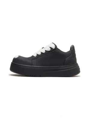 Black spray-finish platform derby shoe shown from the side with oversized white laces, rounded toe, chunky rubber sole, and matte streetwear upper