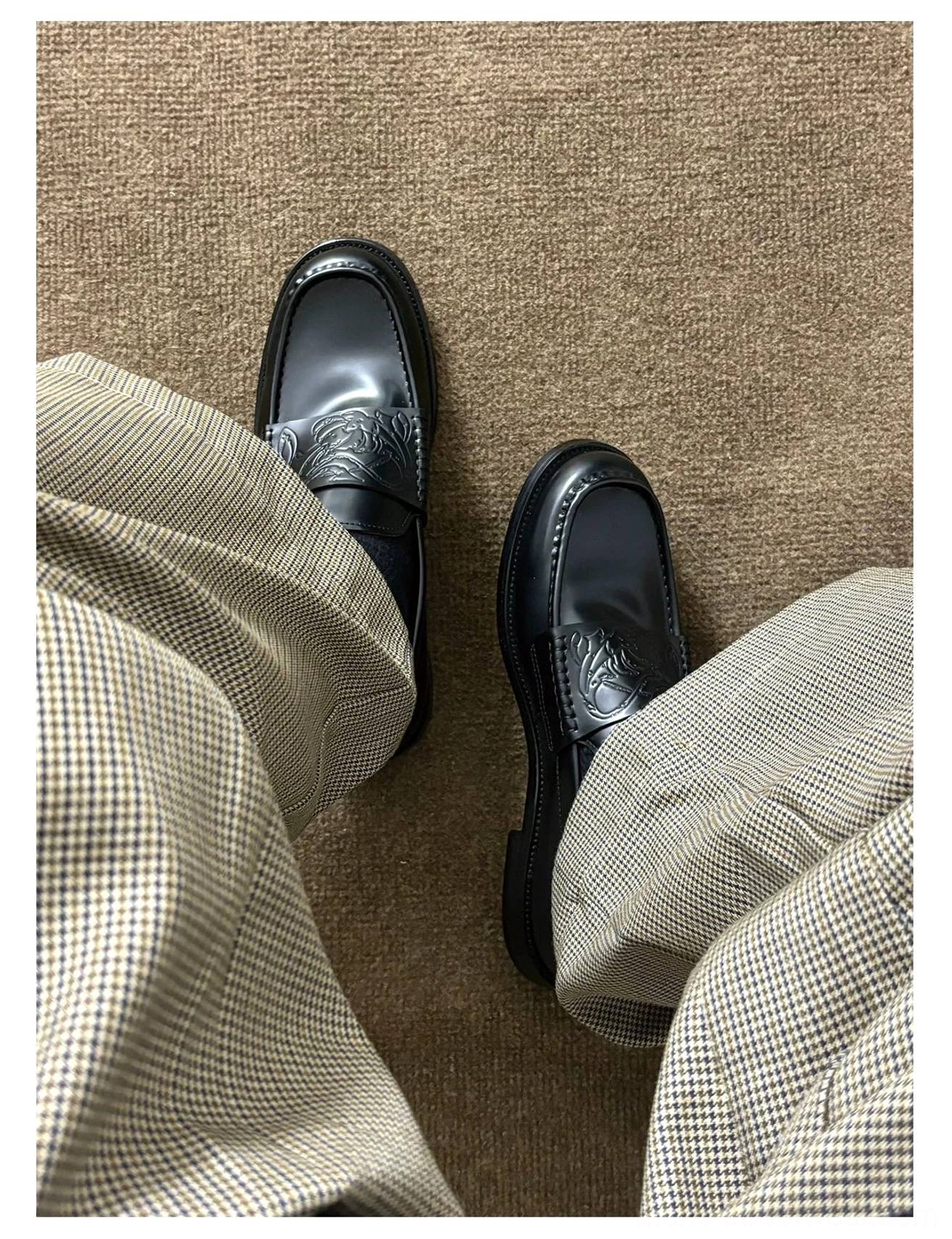 Black square-toe leather loafers with embossed vamp detail, low stacked heel, and burgundy lambskin lining