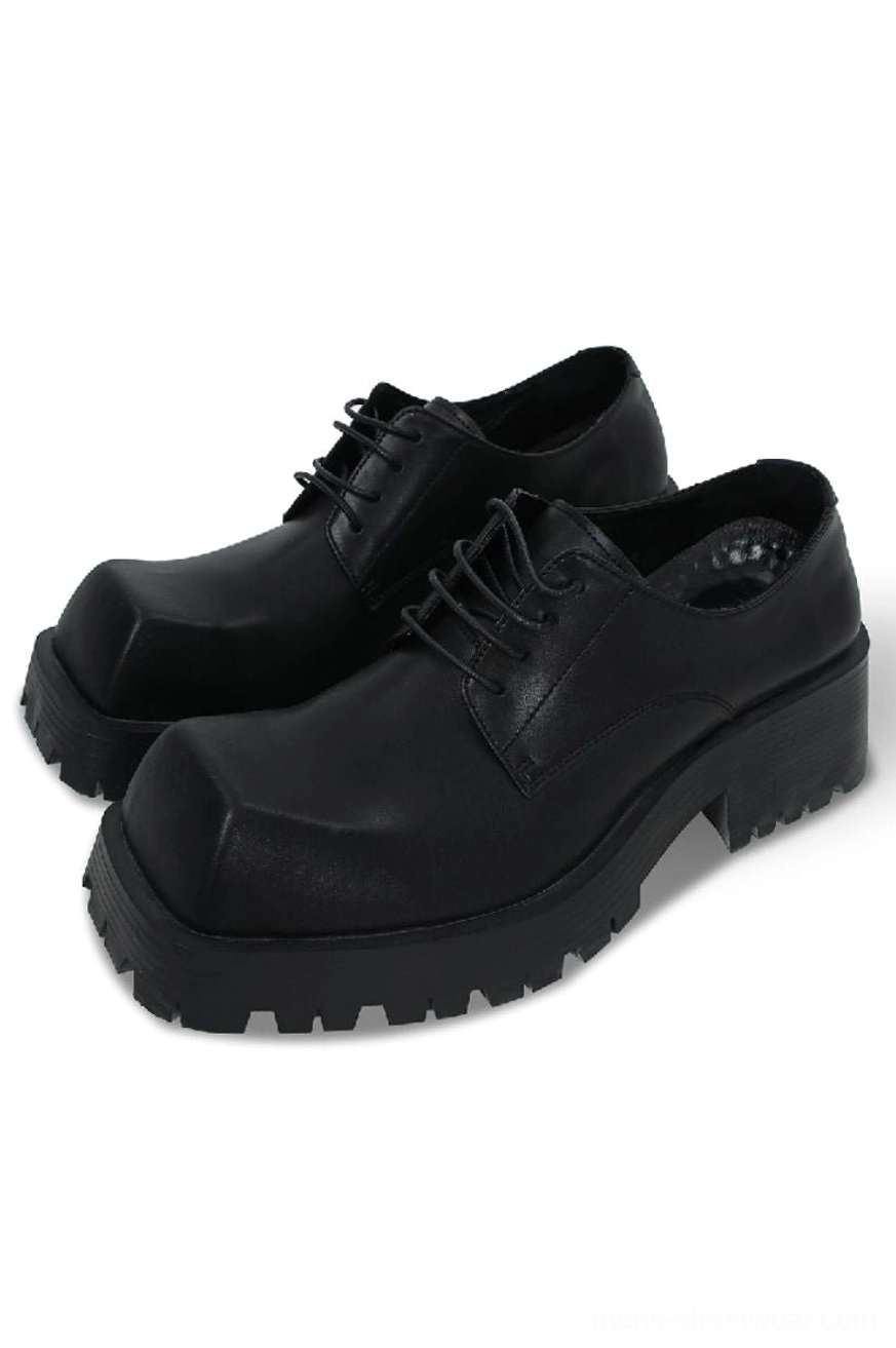 Black square-toe platform chunky Derby shoes shown in three-quarter view with smooth PU upper, lace-up front, and thick lug sole