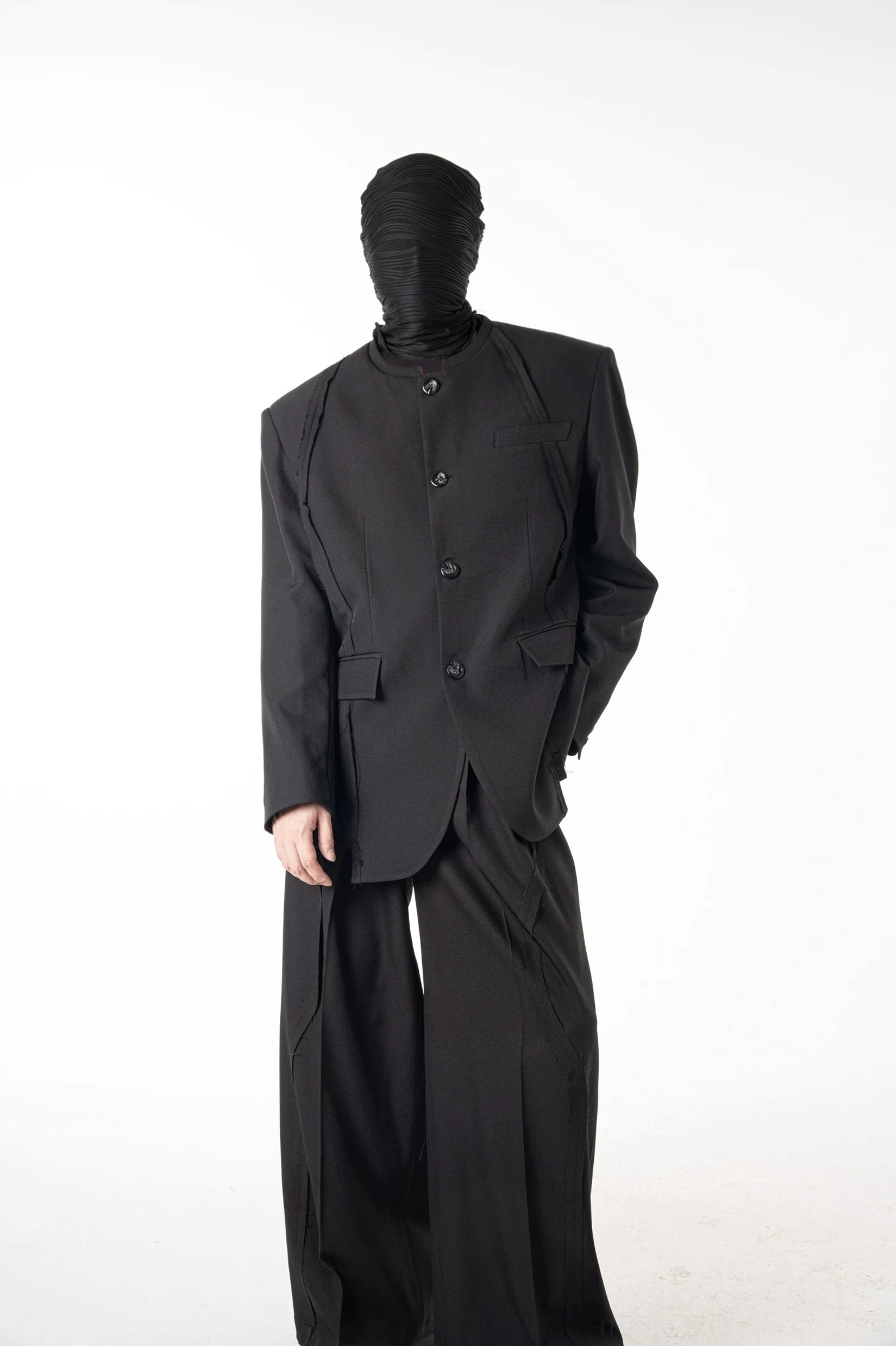 Full body front view of black stand collar blazer suit with relaxed wide-leg trousers and monochrome Korean fashion styling