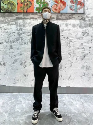 Front view of a black stand collar blazer with white long sleeve T-shirt and ankle-cut trousers styled as a Korean streetwear suit outfit