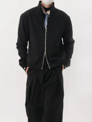 Black stand collar double-zip blouson jacket front full-body view styled with wide-leg black trousers