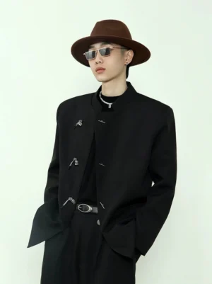 Chinese style black stand collar blazer with silver toggle closures styled with wide-leg trousers, fedora, sunglasses, and layered necklaces