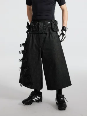 Black strap ladder tactical denim cargo cropped shorts back three-quarter view with wide-leg silhouette and modular side pouch detail