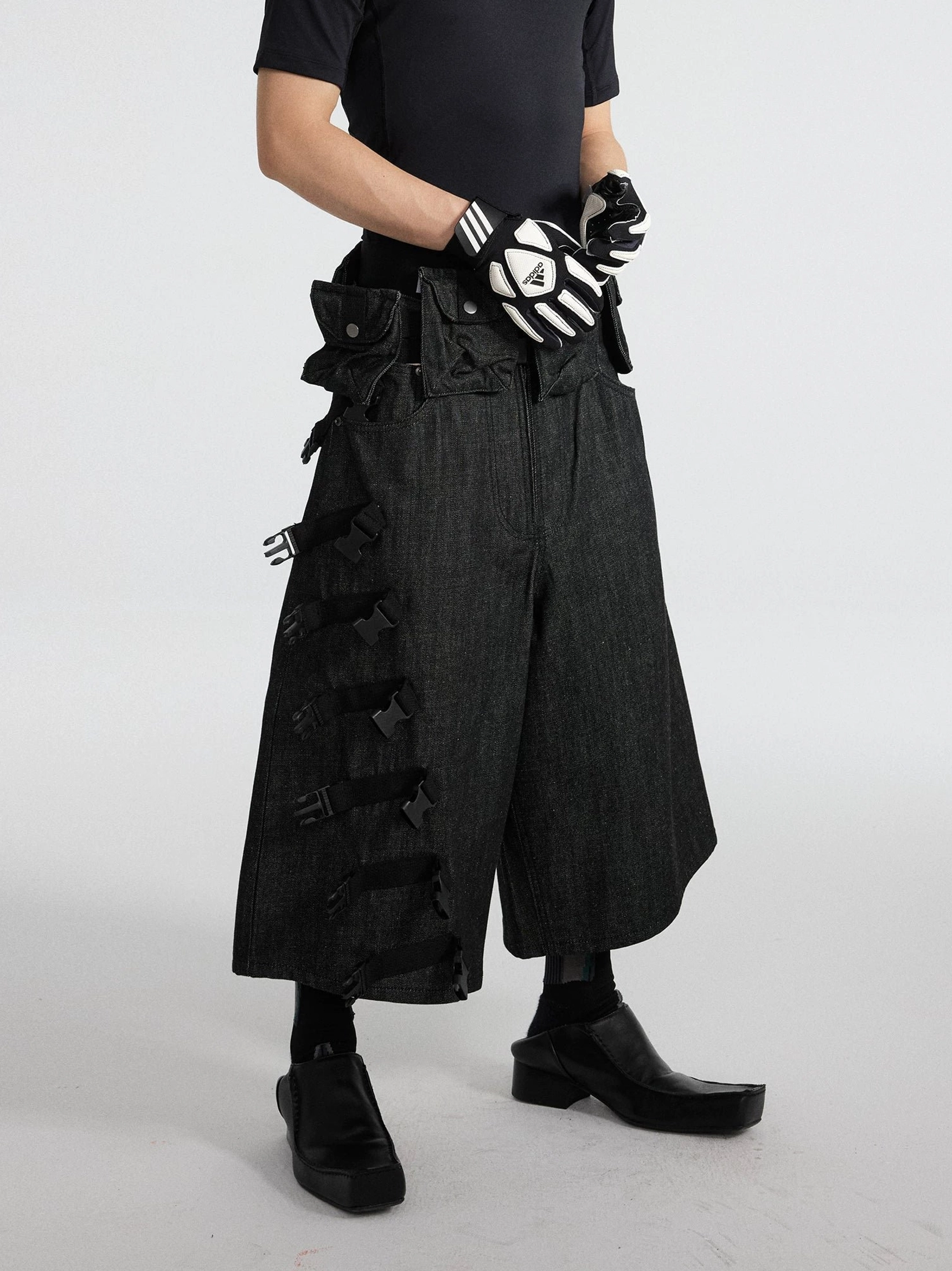 Black strap ladder tactical denim cargo cropped shorts front angled view with detachable side utility pouch system