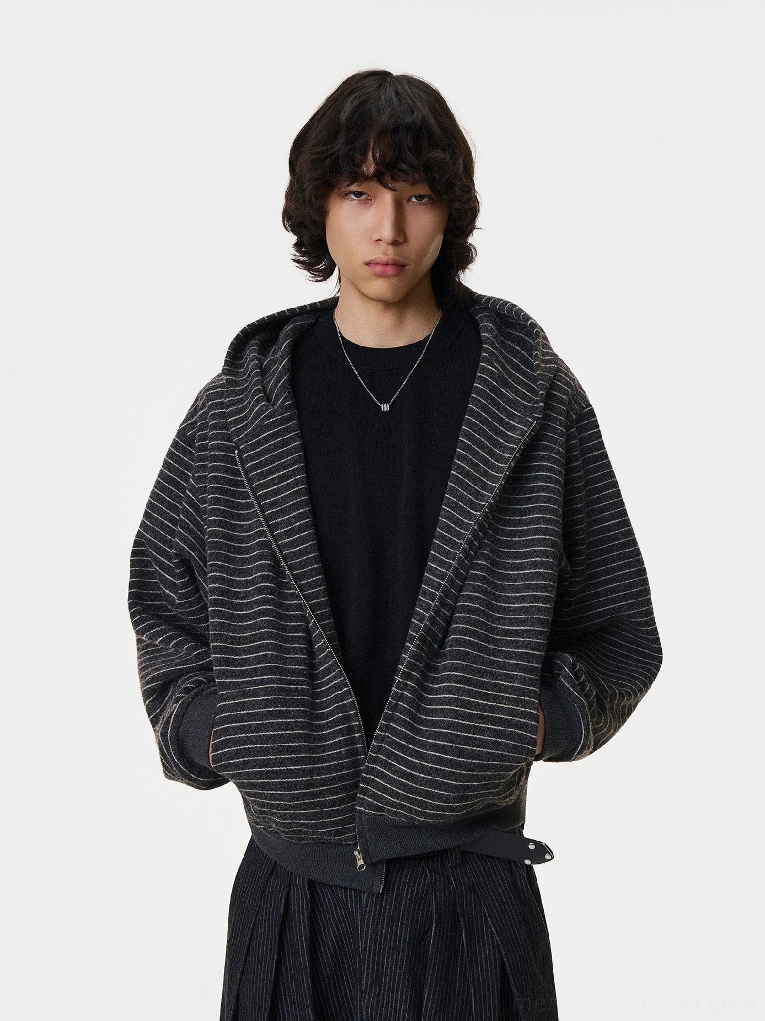 Black striped slouch zip hoodie with silver fox fur trim styled open with a black tee and pleated trousers