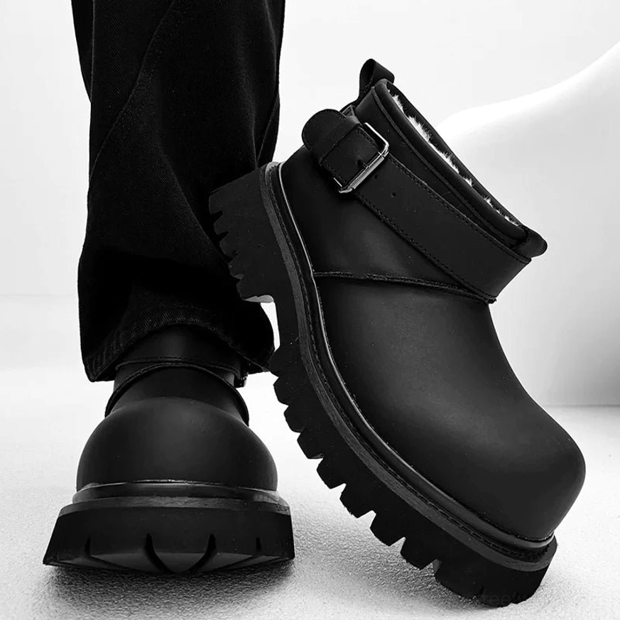 Black suede-finish fleece-lined ankle boots with rounded toe, decorative buckle strap, and heavy lug platform sole