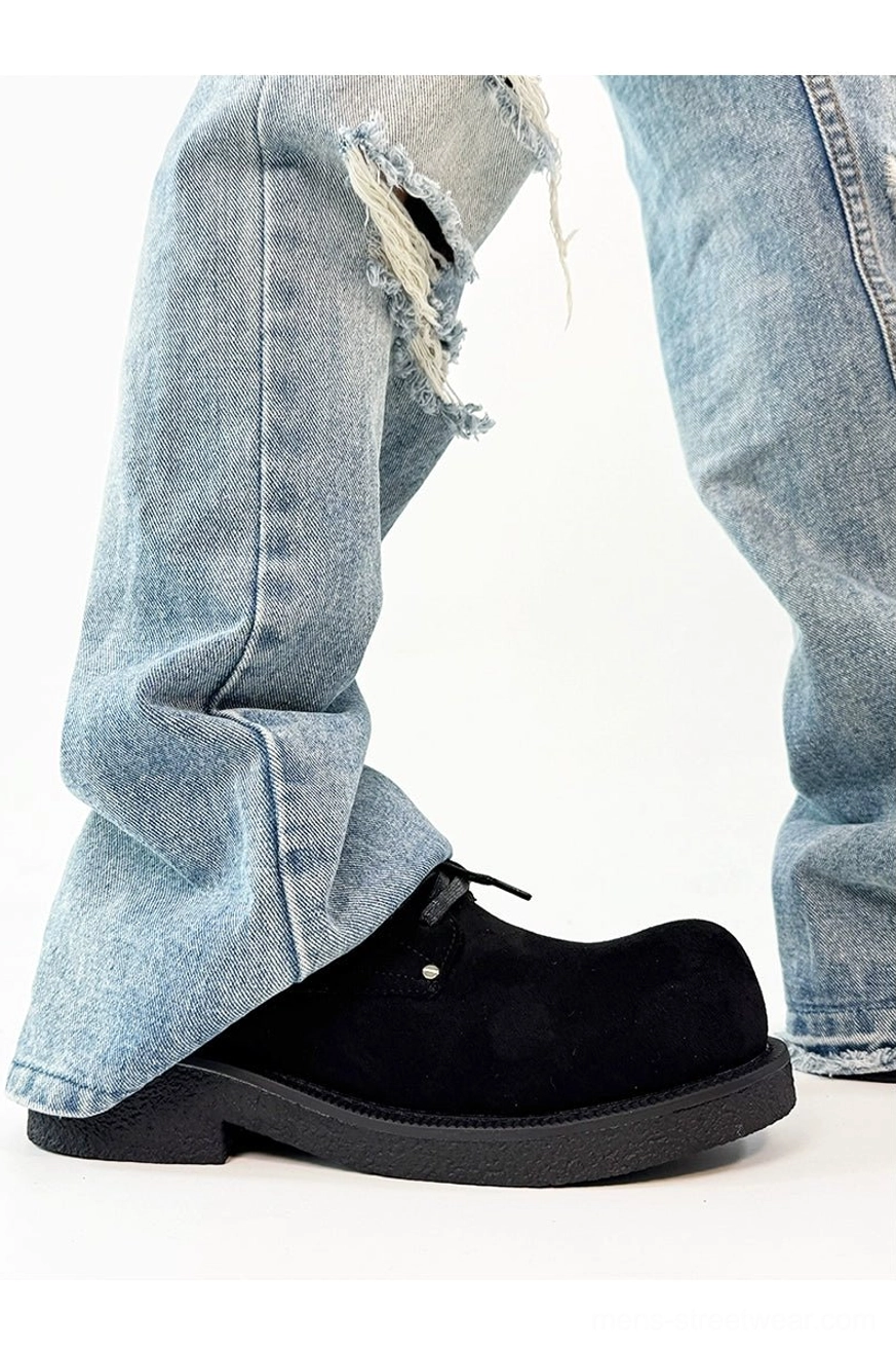 Black suede platform derby shoe side profile showing matte upper, chunky block outsole, round toe, and lace-up front