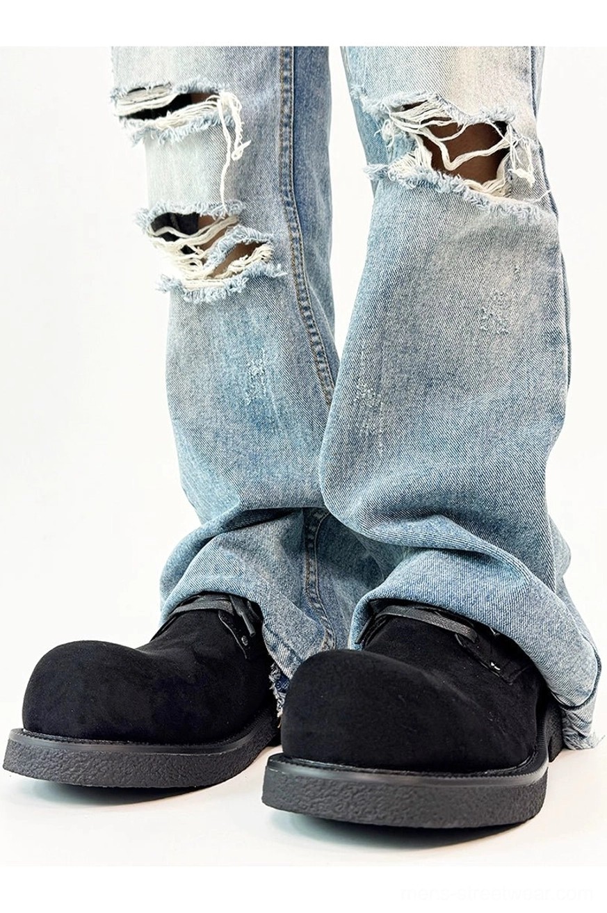 Black suede platform derby shoes front view styled with ripped flared jeans and a substantial black rubber sole