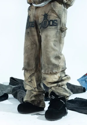 Black suede platform strap boots worn with distressed printed cargo pants in a Korean streetwear outfit, showing the padded high-top silhouette and rounded platform sole
