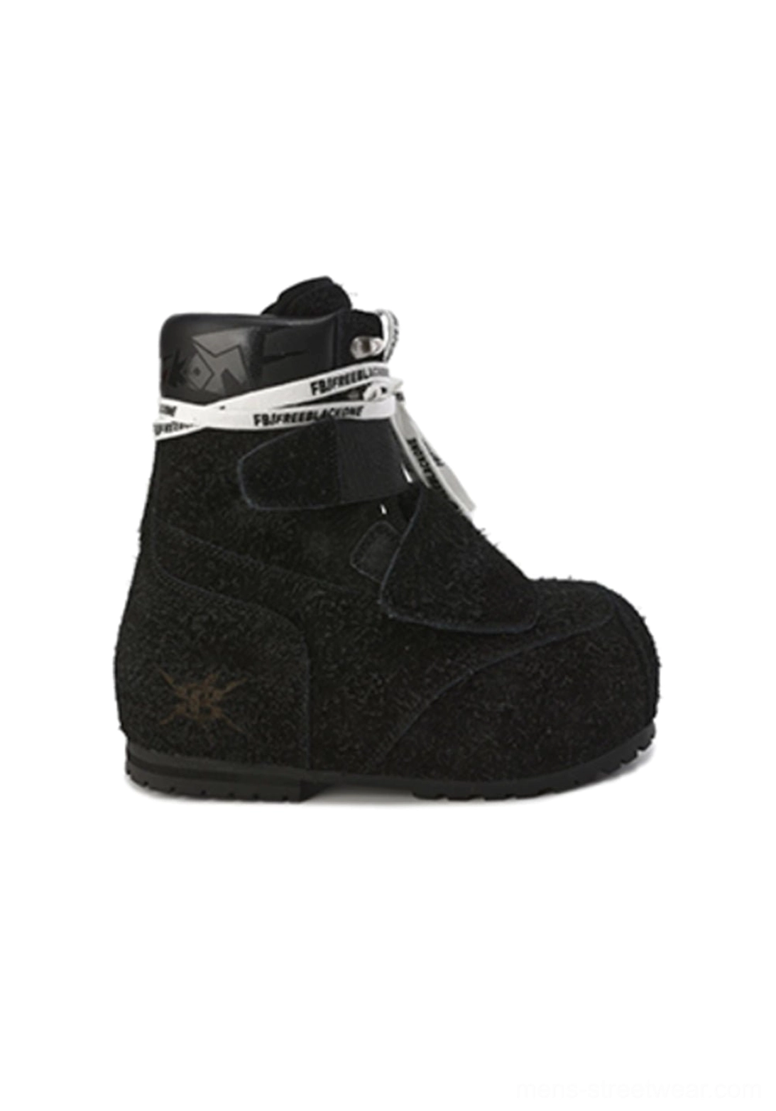 Close-up of a black suede strap platform boot showing the rounded toe, contrast ankle strap detail, embossed toe accent, metal buckles, padded collar, and thick platform sole