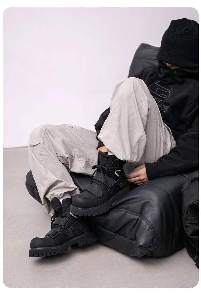 Black tactical streetwear boots styled with dark clothing, cargo pants, and a knit beanie for a modern Seoul-inspired urban outfit