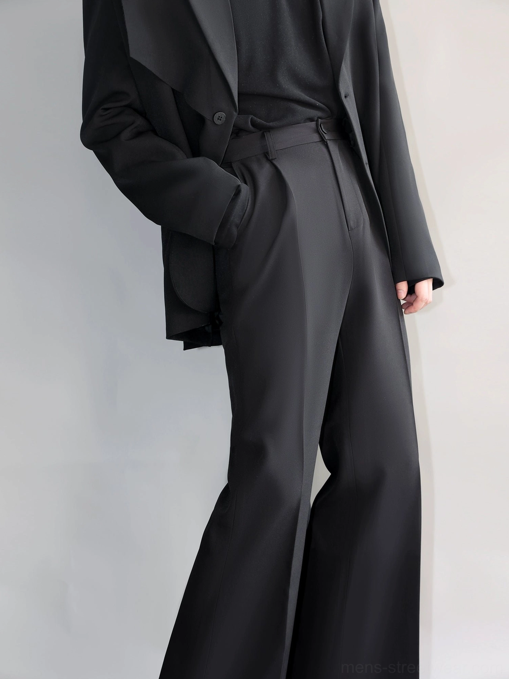 Black tailored straight-leg trousers with side pockets and high-rise waist styled with a black top side angle view