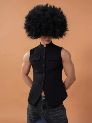 Rear three-quarter view of a fitted black tailored waistcoat showing its clean minimal back panel, slim silhouette, and structured streetwear design