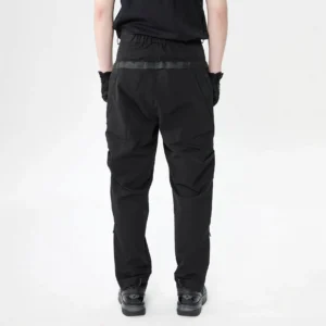 Rear view of black tactical cargo pants showing elastic back waist webbing belt strap and tapered legs
