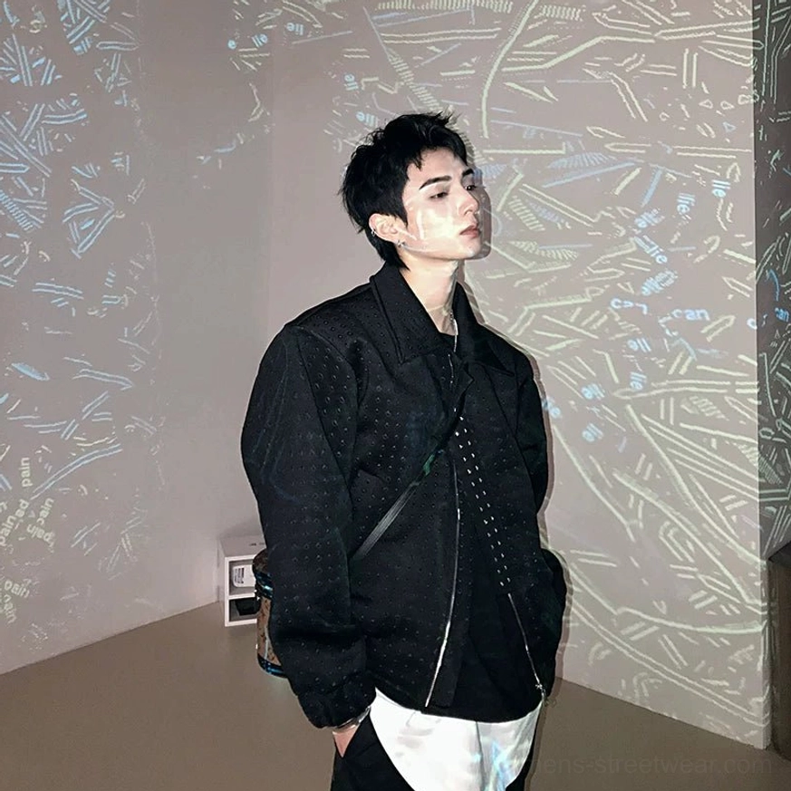 Black textured asymmetric zip jacket shown from a left three-quarter angle with dropped shoulders and layered dark streetwear styling