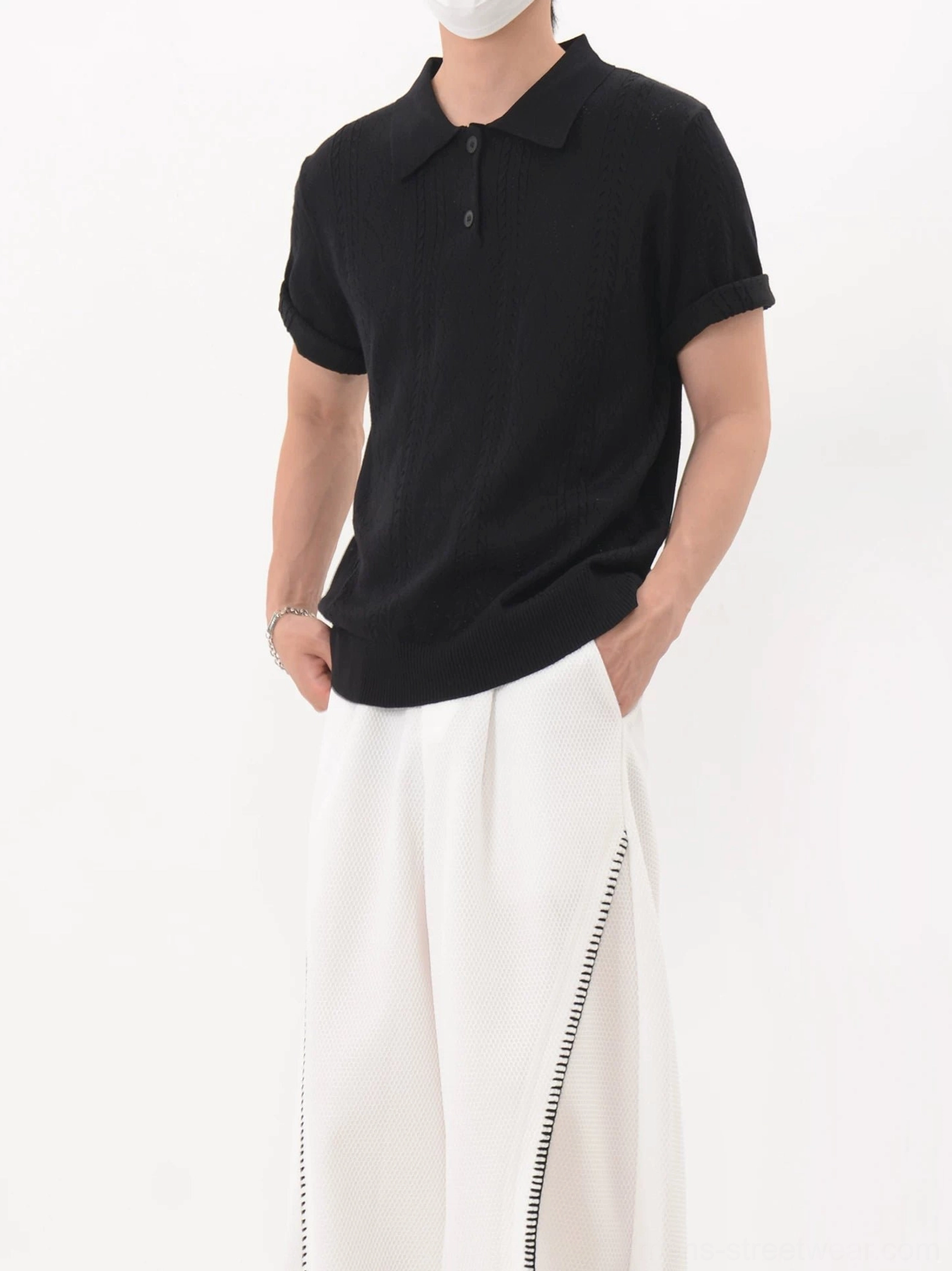 Black textured lattice knit polo shirt with three-button collar, rolled cuffs, and relaxed boxy streetwear fit