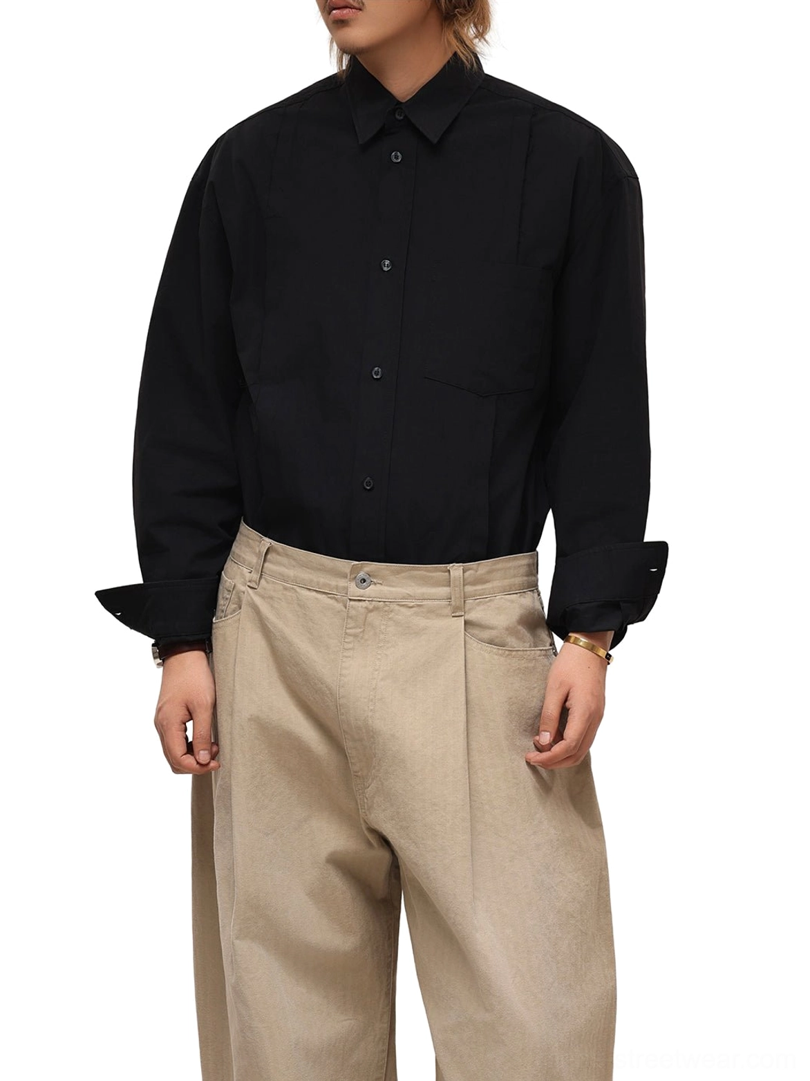Male model wearing relaxed black embroidered poplin streetwear shirt with beige wide leg trousers front view