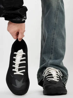 Front view of black trail sneakers with contrasting white laces, breathable matte mesh upper, rounded toe, and modern Korean streetwear styling