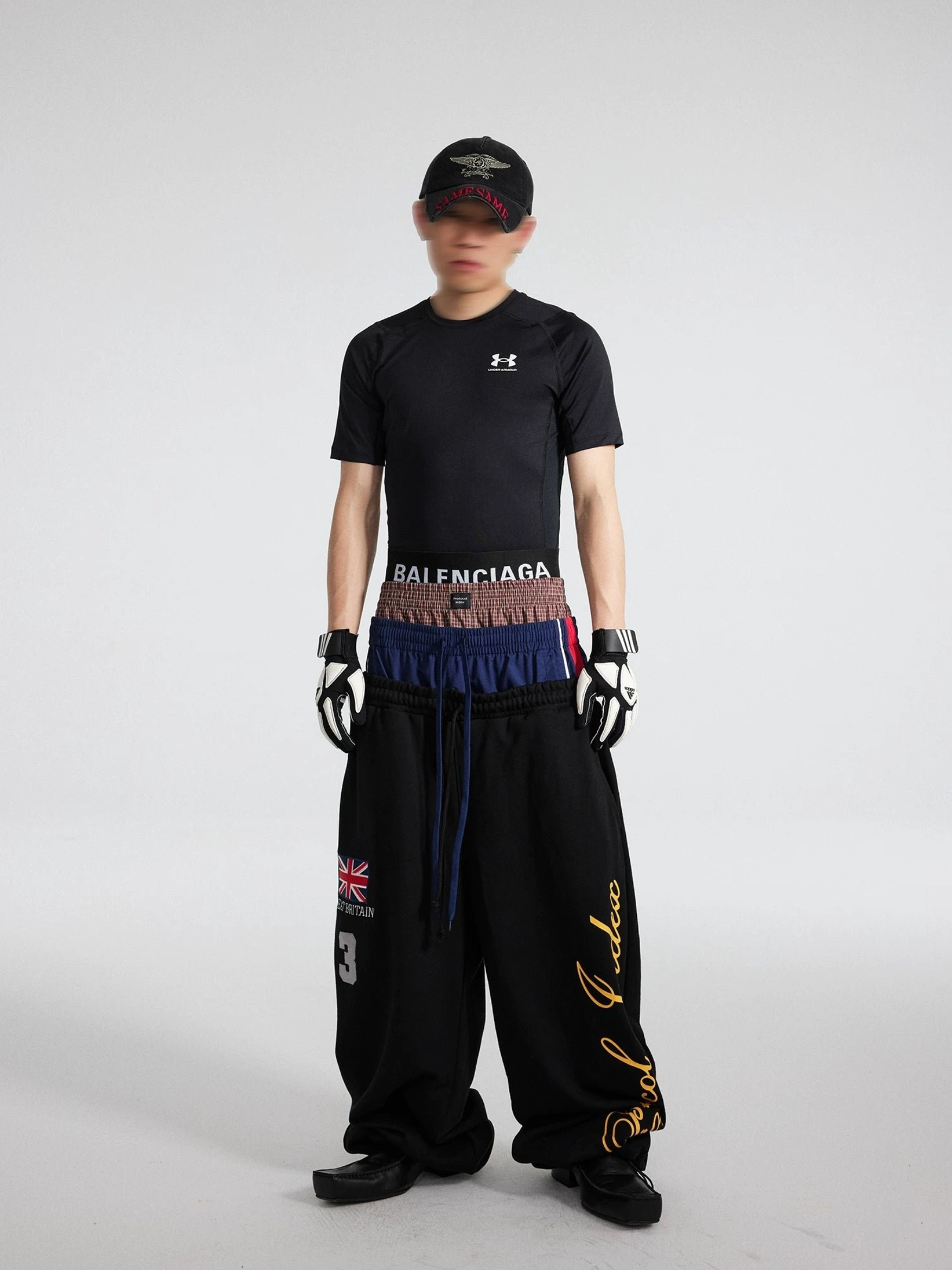 Black triple waist streetwear flared sweatpants with stacked waistband and extra long pooling hem styled on model