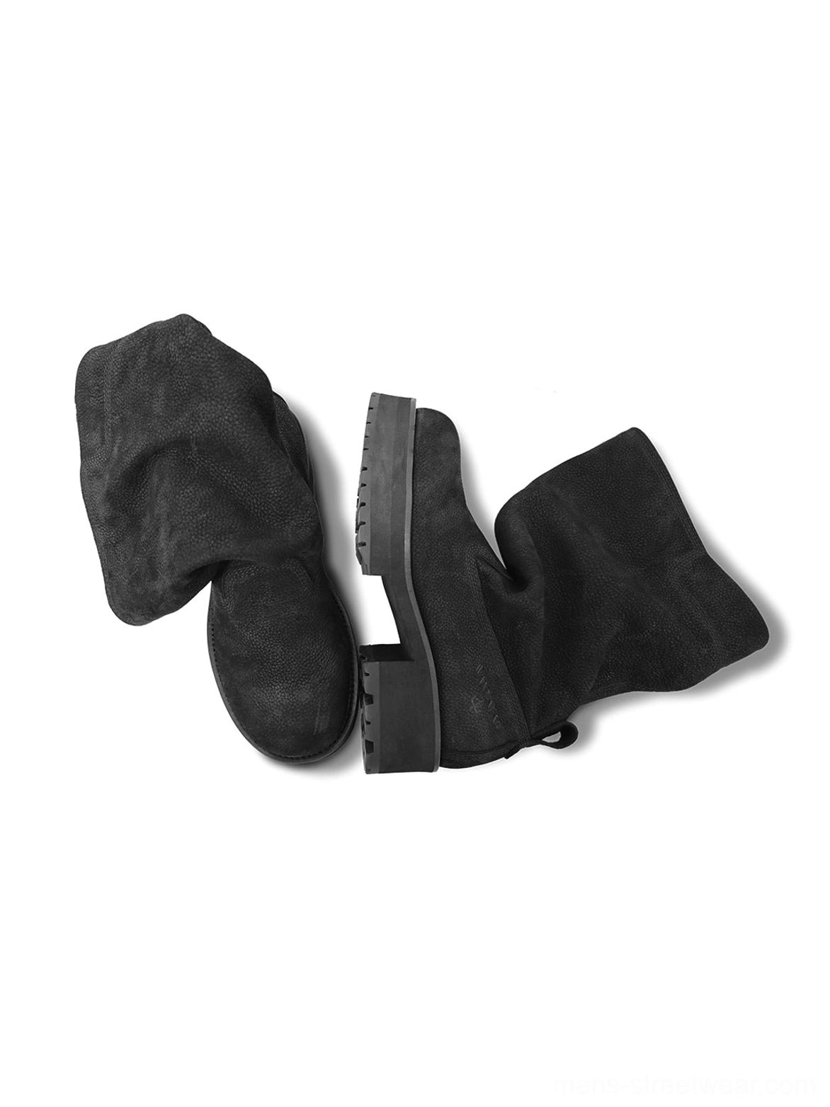 Overhead side view of black tumbled leather slouch mid-calf boots showing folded cuff and treaded rubber outsole