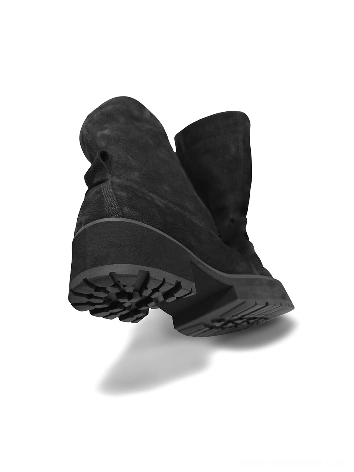 Rear bottom close-up of black tumbled leather slouch mid-calf boot showing pull tab and deep tread outsole