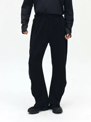 Black drawstring sweatpants front full view showing elastic waistband loose wide leg silhouette and smooth twill fabric texture